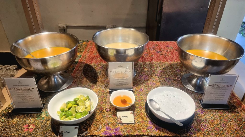 Refreshing jamu or Indonesian traditional concoction of herbs, with honey and lime wedges to enhance the taste to your liking